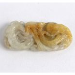 A small carved jade pendant, depicting a phoenix to one side, dragon to the other,