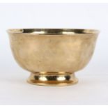A Continental late 17th/early 18th Century brass bowl, raised on a circular foot,