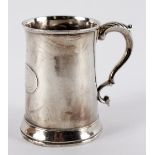 A George III silver mug, LM, London 1773, of tapering form with leaf capped scroll handle, 9cm high,