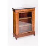 A Victorian mahogany display cabinet enclosed by a glazed door, with surround of chequered banding,