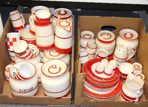 A quantity of red and cream kitchenware including jars for flour and currants, casters, jugs etc.