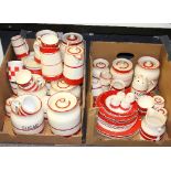 A quantity of red and cream kitchenware including jars for flour and currants, casters, jugs etc.