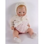 An Armand Marseille bisque dream baby doll with sleepy eyes,