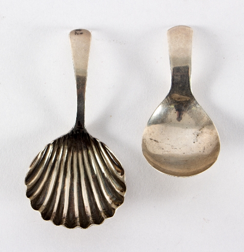 A George III silver caddy spoon, G B, London 1802, with shell bowl and another, J S,