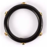 An onyx bangle set with oval cabochons and marked 585 to a small oval plaque