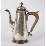 A Georgian silver chocolate pot of tapering form, crested, turned wooden handle, marks rubbed, 17.