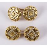 A pair of French 18ct gold and white enamelled cufflinks,