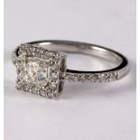 A diamond ring, the central princess cut diamond approximately 0.