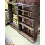 A large oak bookcase of two sections, each fitted three shelves,