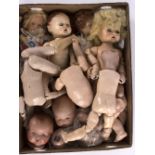 A quantity of various dolls and body components to include a Chad Valley stuffed doll,