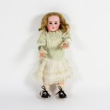 A Tete Jumeau bisque head doll, with sleepy eyes, open mouth and teeth,