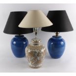 Two blue pottery lamp bases, 28cm high and another with cream and gold pottery base,