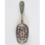 A late 19th Century Russian silver gilt and enamel caddy spoon,