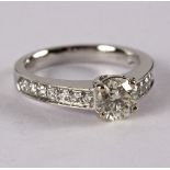 A diamond ring, the central round brilliant cut diamond approximately 0.