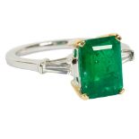 An emerald and diamond dress ring, the central rectangular step cut emerald 2.