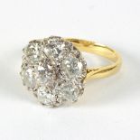 A diamond cluster ring set seven round brilliant cut diamonds, each approximately 0.