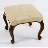 A Victorian walnut framed stool on moulded cabriole legs with knurl feet,
