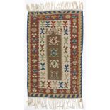 Two Kilim rugs worked in red, blue and green on a red and cream ground,