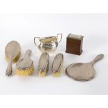 A silver dressing set, Birmingham 1922, comprising four brushes and a hand mirror,