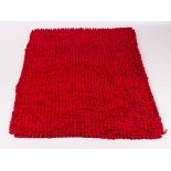 A red pebble rug by Dream Weavers,