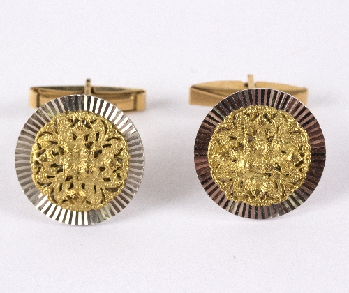 A closely matched pair of cufflinks, marked 18k,