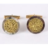 A closely matched pair of cufflinks, marked 18k,