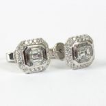 A pair of diamond stud earrings,