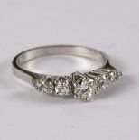 A diamond ring, the central round brilliant cut diamond approximately 0.