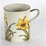 A Wemyss mug painted daffodils within green borders, for T. Goode & Sons, impressed mark, 14.