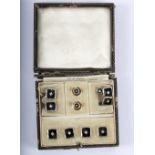 An Art Deco diamond and onyx gentleman's dress set, comprising a pair of cufflinks, four buttons,