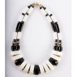 A French black and white enamelled necklace of modern design,