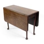 A George II mahogany drop leaf table, the rectangular top with indented corners,