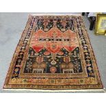 An Eastern prayer rug with all over stylised design within a figured border,