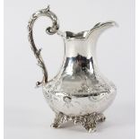 A Victorian silver jug, W S, London 1857, of baluster shape with leaf scroll handle,