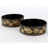 A pair of Regency lacquered and gilt painted wine coasters,