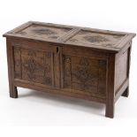 An 18th Century oak chest, carved lozenges to the two-panel top and front,