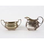 A George III silver jug, T H, London 1810 and a sugar basin, Birmingham 1936,