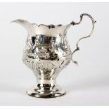 A George III silver jug, Anne Craig & John Neville, London 1765, decorated a rural scene with cow,