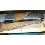 A quantity of various rolls of fabric, to included wool, tweed, linen and suede rolls,