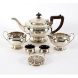 A three-piece silver tea set, Birmingham 1933, of circular shape, two silver salts and a jar cover,