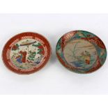 Two Oriental porcelain plates each decorated figures in landscapes, character marks beneath,