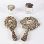 An Art Nouveau silver hand mirror, Birmingham 1905, decorated floral heads,