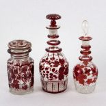 A pair of octagonal tapered decanters, with ruby coloured decoration, 23cm high,