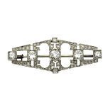 An Art Deco diamond brooch centred a round mixed cut diamond of approximately 0.