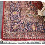 An Eastern carpet, red ground with multiple border,