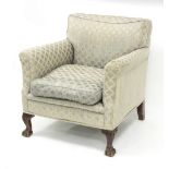 An upholstered armchair on carved legs,