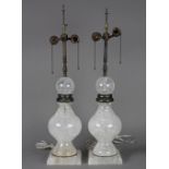 Pair of rock crystal table lamps, each having a baluster form and rising on a square base, 27"h x