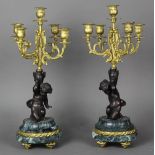 Pair of Clodion style bronze, marble, and gilt metal candelabra, each having five lights surmounting