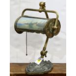 Pairpoint style reverse painted desk lamp, having a scenic decorated adjustable shade and rising