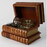 French faux book-form tantalus, 19th century, having a hinged top opening to two decanters and